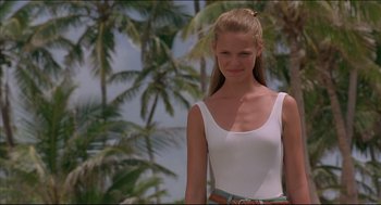 Movie still from “My Father the Hero” (1994), directed by Steve Miner – A beautiful young woman standing in front of palm trees; Medium shot, Low angle
