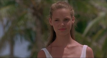 Movie still from “My Father the Hero” (1994), directed by Steve Miner – A beautiful young lady wearing a white top; Close Up shot, Low angle