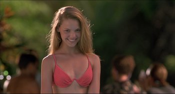 Movie still from “My Father the Hero” (1994), directed by Steve Miner – A young woman in a pink bikini is posing for the camera; Close Up shot, High angle