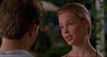 Movie still from “My Father the Hero” (1994), directed by Steve Miner – A young girl looking at a young man; Close Up shot, Over the shoulder angle
