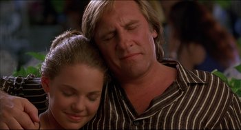 Movie still from “My Father the Hero” (1994), directed by Steve Miner – A man and a woman are hugging and smiling; Close Up shot, Low angle