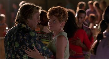 Movie still from “My Father the Hero” (1994), directed by Steve Miner – A man and a woman dancing in a crowd; Medium shot, Low angle