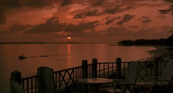 Movie still from “My Father the Hero” (1994), directed by Steve Miner – The sun is setting over the water and the ocean; Extreme Wide shot, High angle