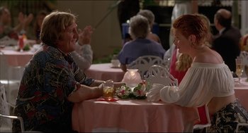 Movie still from “My Father the Hero” (1994), directed by Steve Miner – A man and a woman sitting at a table with a lit candle; Medium shot, Over the shoulder angle