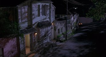 Movie still from “My Father the Hero” (1994), directed by Steve Miner – A street scene with a building and a street light; Extreme Wide shot, High angle