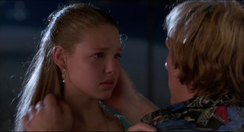 Movie still from “My Father the Hero” (1994), directed by Steve Miner – A young girl looking at a young man in a mirror; Close Up shot, Over the shoulder angle