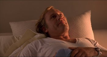 Movie still from “My Father the Hero” (1994), directed by Steve Miner – A man laying in bed with his eyes closed; Close Up shot, Low angle