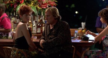 Movie still from “My Father the Hero” (1994), directed by Steve Miner – A man and a woman sitting at a table; Medium shot, Low angle