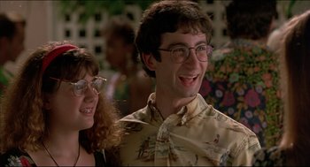 Movie still from “My Father the Hero” (1994), directed by Steve Miner – A man and a woman smiling for the camera; Close Up shot, Low angle