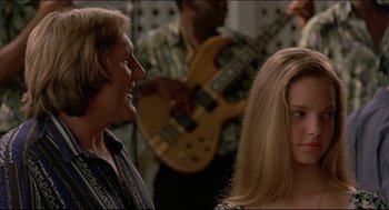 Movie still from “My Father the Hero” (1994), directed by Steve Miner – A man and a woman in front of a guitar; Close Up shot, Over the shoulder angle
