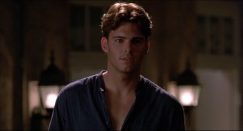 Movie still from “My Father the Hero” (1994), directed by Steve Miner – A young man in a blue shirt is looking at the camera; Close Up shot, Over the shoulder angle