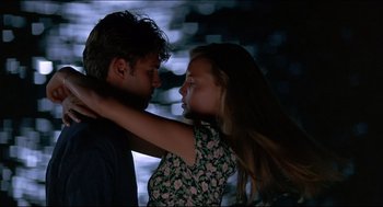 Movie still from “My Father the Hero” (1994), directed by Steve Miner – A man and a woman embracing each other in the dark; Medium shot, Low angle