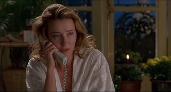 Movie still from “My Father the Hero” (1994), directed by Steve Miner – A woman talking on a phone while sitting in a room; Close Up shot, Low angle