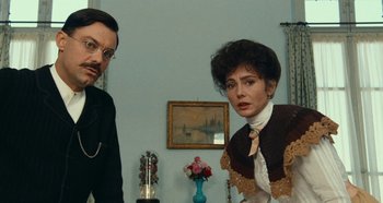 Movie still from “My Father's Glory” (1990), directed by Yves Robert – A man and a woman standing next to each other in a room; Medium shot, Low angle