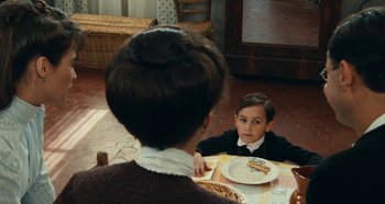 Movie still from “My Father's Glory” (1990), directed by Yves Robert – A woman sitting at a table with a child; Close Up shot, Over the shoulder angle