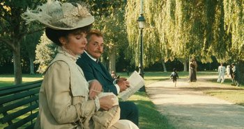 Movie still from “My Father's Glory” (1990), directed by Yves Robert – A man and a woman sitting on a park bench; Medium shot, High angle