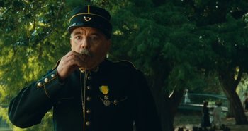 Movie still from “My Father's Glory” (1990), directed by Yves Robert – An old man in a military uniform drinking from a straw; Close Up shot, Low angle