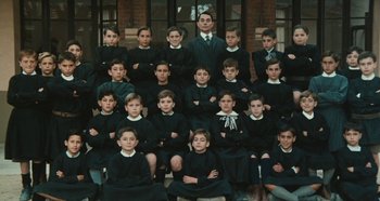 Movie still from “My Father's Glory” (1990), directed by Yves Robert – A group of young boys in school uniforms posing for a picture; Wide shot, High angle