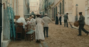 Movie still from “My Father's Glory” (1990), directed by Yves Robert – A group of people standing on a dirt road; Wide shot, High angle
