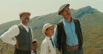 Movie still from “My Father's Glory” (1990), directed by Yves Robert – A group of men standing next to each other; Medium shot, Low angle