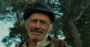 Movie still from “My Father's Glory” (1990), directed by Yves Robert – An old man with a hat and a beard; Close Up shot, Low angle