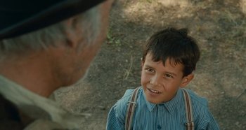 Movie still from “My Father's Glory” (1990), directed by Yves Robert – An older man and a young boy smiling for the camera; Close Up shot, Over the shoulder angle