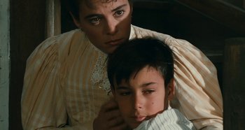Movie still from “My Father's Glory” (1990), directed by Yves Robert – A man and a boy are looking at the camera; Close Up shot, High angle