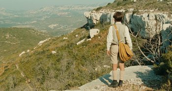 Movie still from “My Father's Glory” (1990), directed by Yves Robert – A man standing on a cliff looking at a valley; Wide shot, High angle