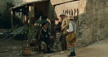 Movie still from “My Father's Glory” (1990), directed by Yves Robert – A group of people standing next to each other on a street; Wide shot, Over the shoulder angle