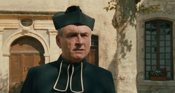 Movie still from “My Father's Glory” (1990), directed by Yves Robert – An older man wearing a green hat and a black suit; Close Up shot, Low angle