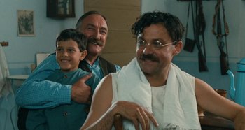 Movie still from “My Father's Glory” (1990), directed by Yves Robert – Two men and a boy smiling for the camera; Medium shot, Low angle