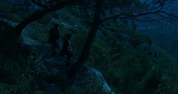 Movie still from “My Father's Glory” (1990), directed by Yves Robert – A couple of people walking up a hill at night; Extreme Wide shot, High angle