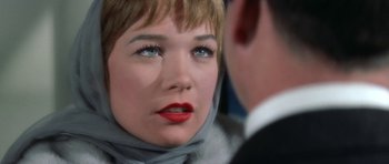 Movie still from “My Geisha” (1962), directed by Jack Cardiff – A person wearing a suit and a scarf; Close Up shot, Over the shoulder angle