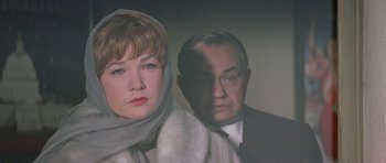 Movie still from “My Geisha” (1962), directed by Jack Cardiff – A man and a woman are standing next to each other; Close Up shot, Low angle