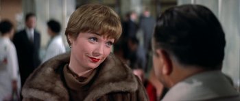 Movie still from “My Geisha” (1962), directed by Jack Cardiff – A person wearing a fur coat; Close Up shot, Over the shoulder angle