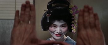 Movie still from “My Geisha” (1962), directed by Jack Cardiff – A geisha is taking a selfie in front of a mirror; Close Up shot, Over the shoulder angle