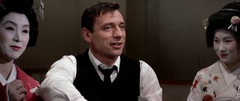 Movie still from “My Geisha” (1962), directed by Jack Cardiff – A person wearing a vest and a tie; Close Up shot, Over the shoulder angle