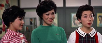 Movie still from “My Geisha” (1962), directed by Jack Cardiff – A woman in a green shirt smiling for the camera; Close Up shot, Over the shoulder angle
