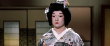 Movie still from “My Geisha” (1962), directed by Jack Cardiff – A geisha in a kimono is standing in front of a window; Close Up shot, High angle