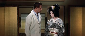 Movie still from “My Geisha” (1962), directed by Jack Cardiff – A man standing next to a woman wearing a kimono; Medium shot, Over the shoulder angle