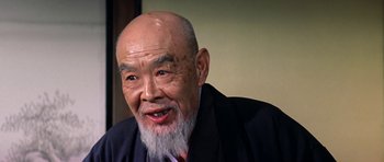 Movie still from “My Geisha” (1962), directed by Jack Cardiff – An older man with a beard and a suit; Close Up shot, Low angle