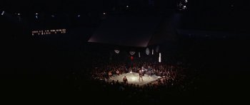 Movie still from “My Geisha” (1962), directed by Jack Cardiff – A crowd of people sitting in a circle watching a sumo match; Extreme Wide shot, High angle