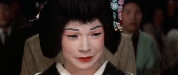 Movie still from “My Geisha” (1962), directed by Jack Cardiff – A geisha is wearing a black wig and a black dress; Close Up shot, High angle