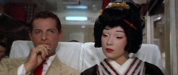 Movie still from “My Geisha” (1962), directed by Jack Cardiff – A man sitting next to a geisha woman; Close Up shot, Over the shoulder angle