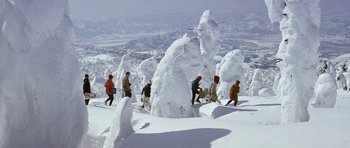 Movie still from “My Geisha” (1962), directed by Jack Cardiff – A group of skiers on a snowy mountain; Extreme Wide shot, High angle