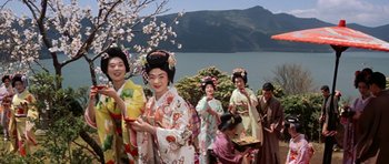 Movie still from “My Geisha” (1962), directed by Jack Cardiff – A group of geishas standing next to each other near a body of water; Extreme Wide shot, Low angle