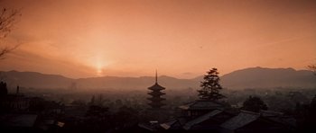 Movie still from “My Geisha” (1962), directed by Jack Cardiff – The sun is setting over the mountains with a pagoda in the foreground; Extreme Wide shot, Low angle
