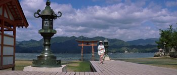 Movie still from “My Geisha” (1962), directed by Jack Cardiff – A woman in a white kimono walking on a pier; Extreme Wide shot, Low angle