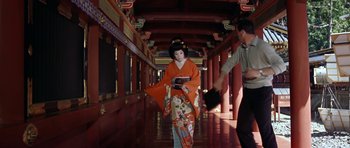 Movie still from “My Geisha” (1962), directed by Jack Cardiff – A woman in an orange kimono walking down a hallway; Wide shot, Low angle