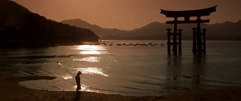 Movie still from “My Geisha” (1962), directed by Jack Cardiff – A person standing on a beach near the water; Extreme Wide shot, Low angle